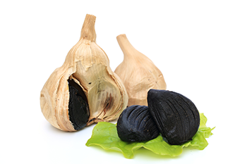Black garlic on white background