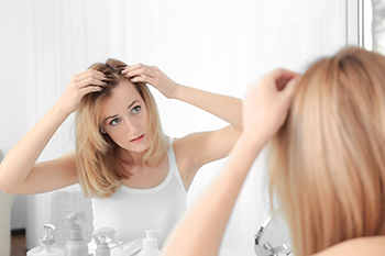 woman checking hairline coping PCOS