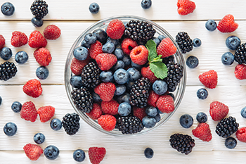 a bowl of berries coping PCOS