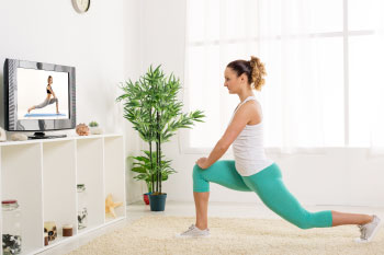 woman working out in living room stress busters